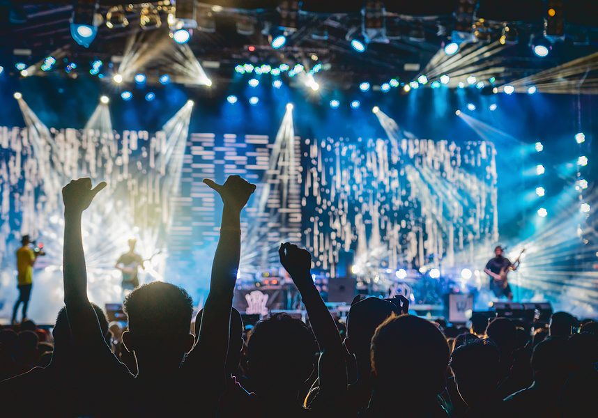 Concert Crowd In Silhouettes Of Music Fanclub With Show Hand Act concert full with people and a band